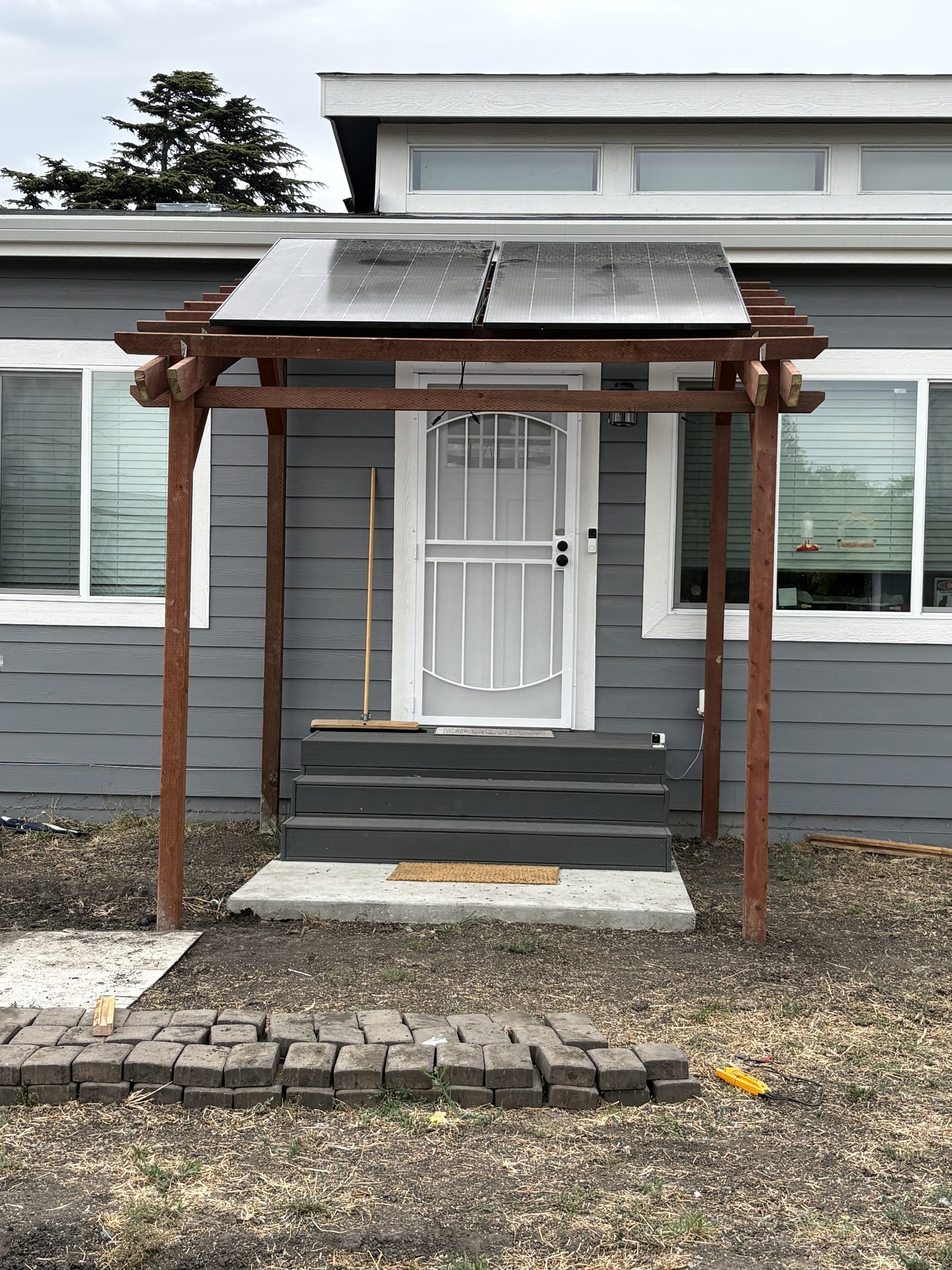 Bright Saver solar panels mounted on a custom Astral redwood pergola